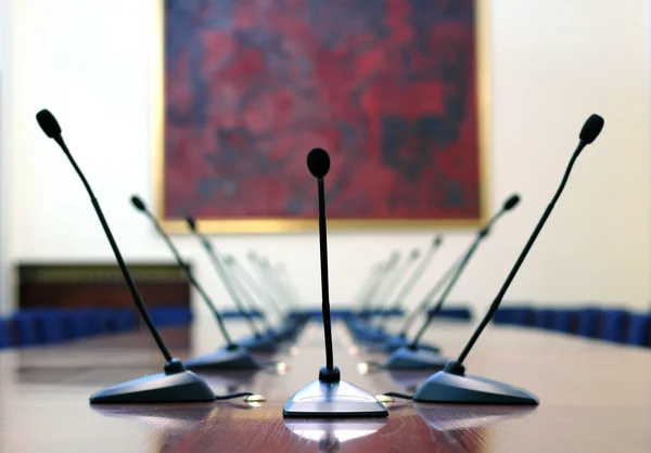 Microphones in empty conference hall — Stock Photo, Image