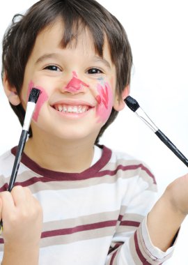 Cute little boy getting make-up on his clipart