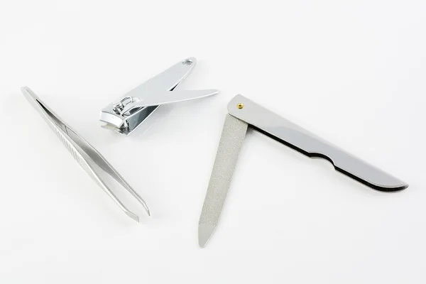 Nail cutter, nail file and pincer — Stock Photo, Image