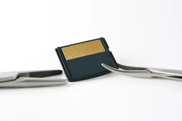 stock image Surgical clamp and memory card