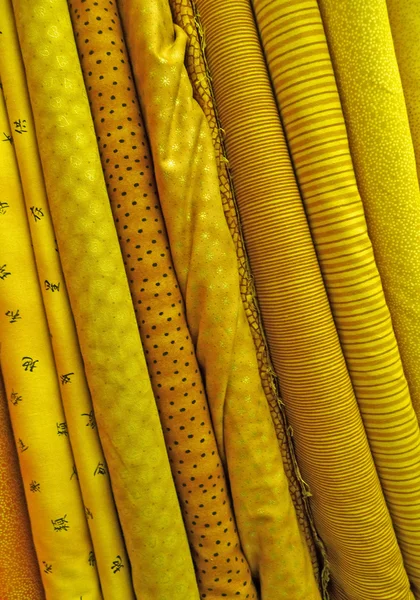 Assorted yellow fabrics background — Stock Photo, Image