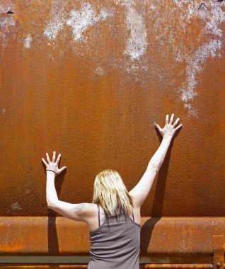 Blond woman with rusty metal background clipart