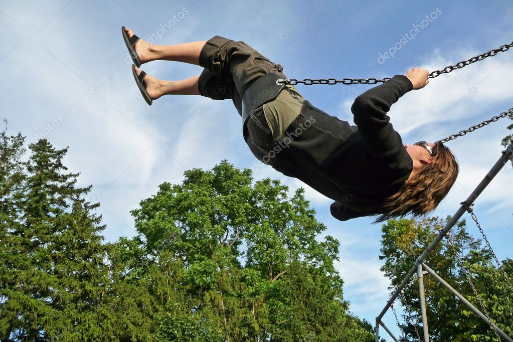 Woman swinging high on swing set — Stock Photo © evoken68 2206092