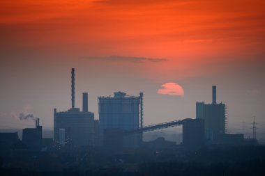 Industrial skyline at sunset clipart