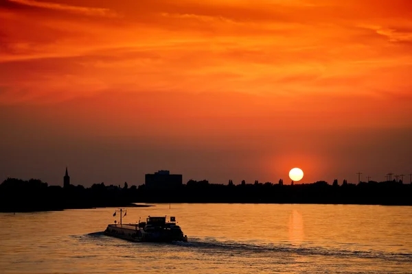 Stock image Barge with cargo at sunset