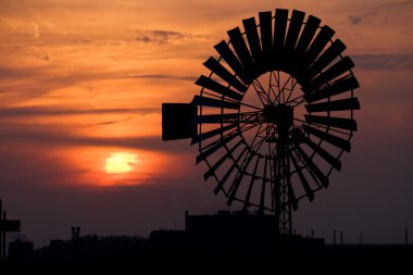 Windmill at sunset clipart