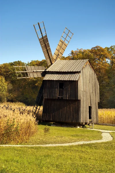 Wooden windmill with forest — Stock Photo, Image
