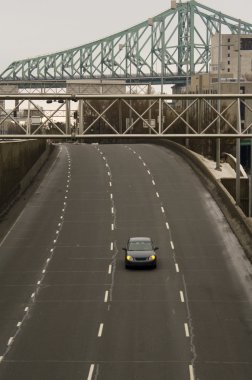 One car on four lane highway bridge clipart