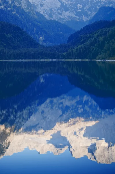 Picchi montuosi che si riflettono nel lago — Foto Stock