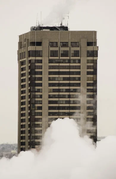 Tall apartment buiding in white smoke — Stock Photo, Image
