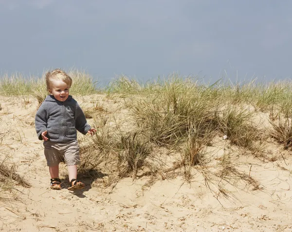 Little boy on sand dunes — Stock Photo, Image