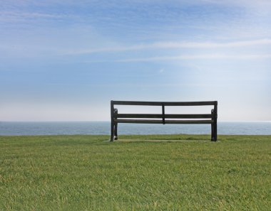 Empty bench at seaside clipart