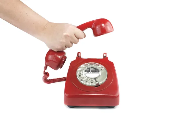 Atendendo um telefone vermelho antiquado — Fotografia de Stock