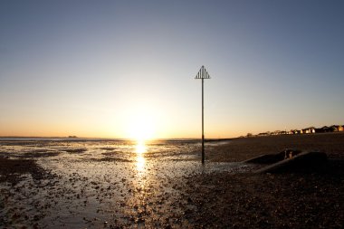 Sunset at mersea island in essex clipart