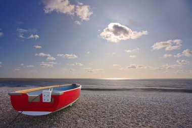 Red boat on beach clipart