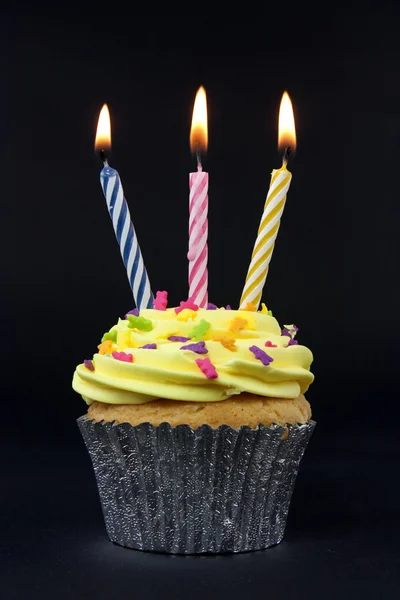 Cupcake on black with 3 candles — Stock Photo, Image