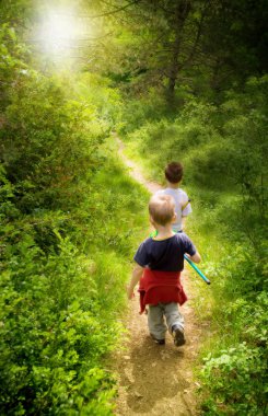 Young children walking in forest clipart