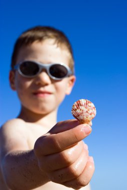 Young child on the beach clipart