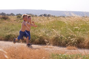 Young children running in the nature clipart