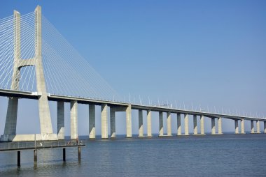 Modern bridge in river Tejo, Portugal. clipart