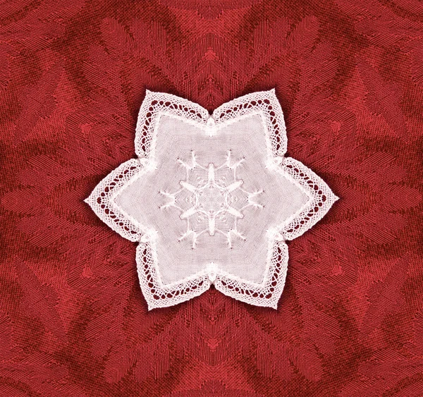 Koronkowa gwiazdka na czerwony gobelin — Zdjęcie stockowe