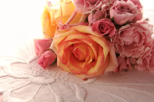 Roses on embroidered fabric — Stock Photo, Image