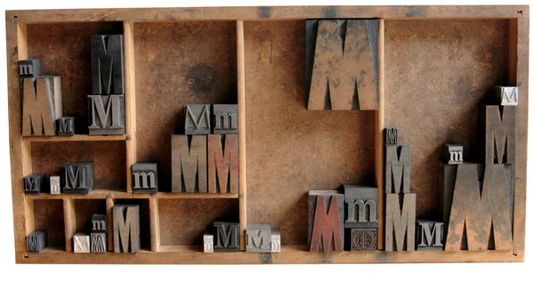 Letterpress M in wood and metal in a type — стоковое фото
