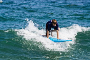 Teenage Boy Surfing clipart