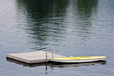 Docked Boat on Lake clipart