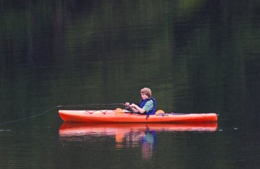 Fishing from Kayak clipart