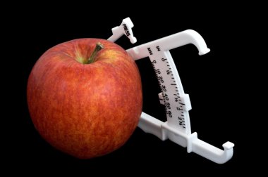 Apple and Calipers Over Black clipart