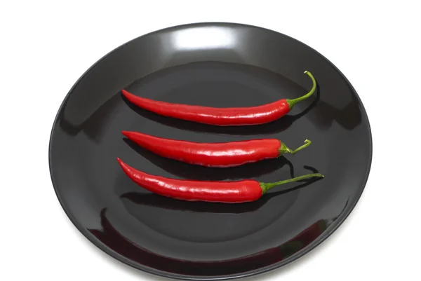Tree red chili peppers on a plate — Stock Photo, Image