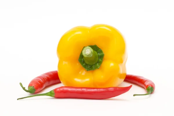 Yellow pepper with red chili peppers — Stock Photo, Image