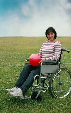 Woman in wheelchair in park clipart