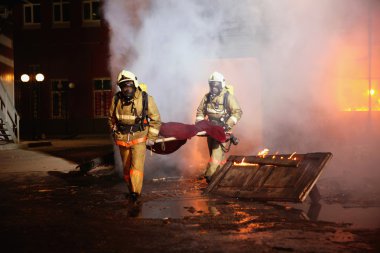 Firefighters carrying an accident victim clipart