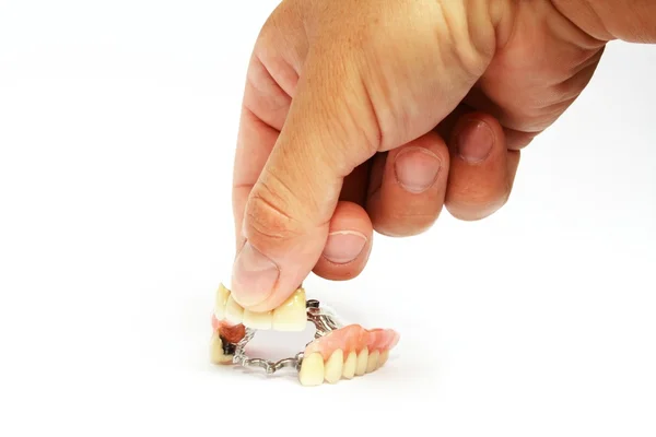 Dentures on a hand — Stock Photo, Image