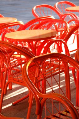 Metal orange cafe table and chairs clipart