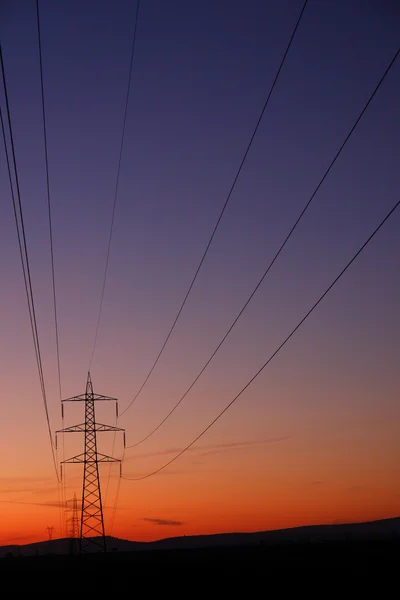 Пілон електрики на заході сонця Ліцензійні Стокові Фото