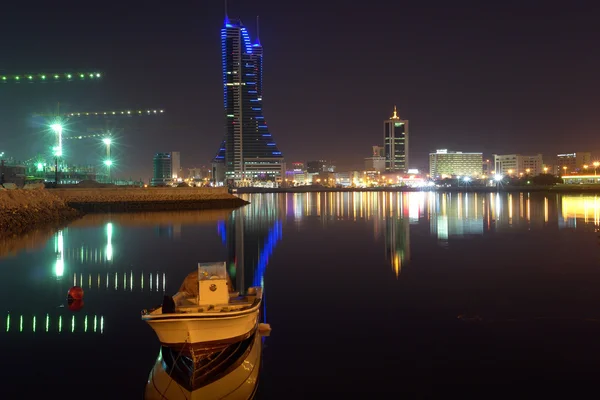 Bahrain financial harbor and boat in sea Stock Image