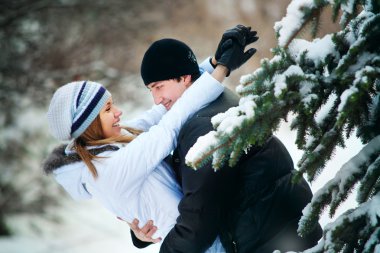 Young couple playing outdoors. clipart