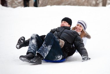 Couple riding a sleigh. clipart