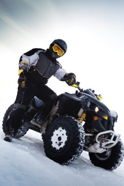 Rider costs near to ATV. Winter season clipart