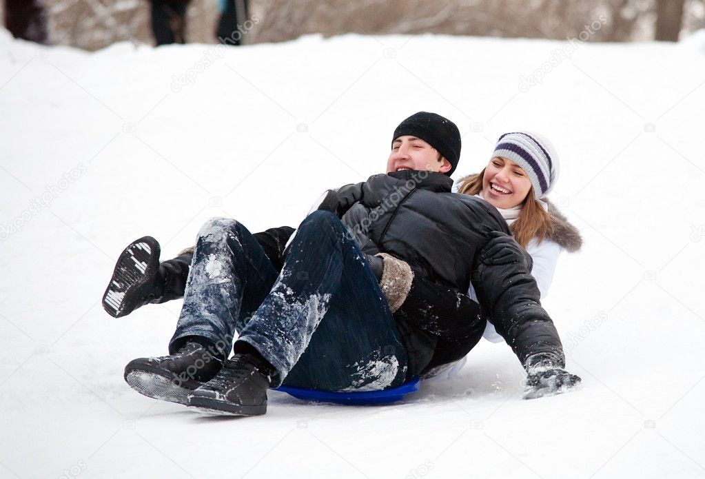 Couple riding a sleigh.