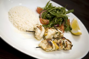 A dish of Monkfish skewers with Basmati rice clipart