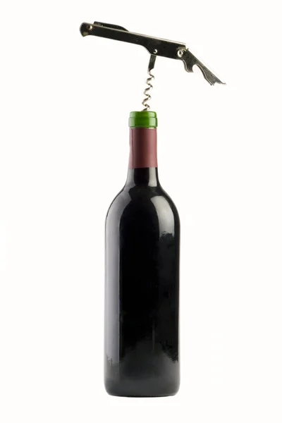 A Bottle of red wine with a corkscrew — Stock Photo, Image