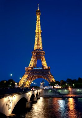 Eiffel tower illuminated at dusk. clipart