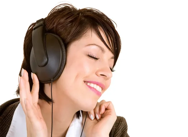 Lady lyssna på musik med hörlurar Stockbild