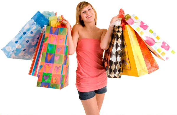 年轻的女子在疯狂购物 免版税图库图片