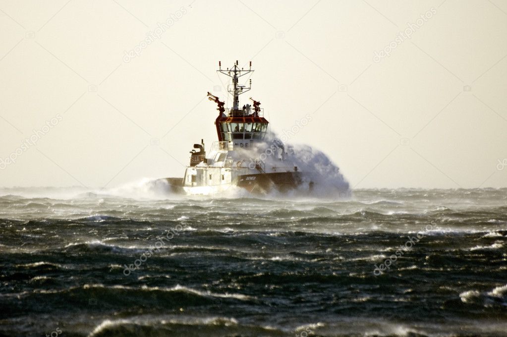 Tuboat ploughing a rough sea
