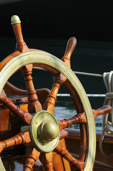 Wooden and brass rudder on a vintage vessel